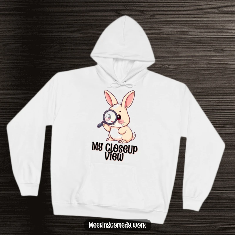 Funny hoodie featuring an inquisitive rabbit using a magnifying glass, perfect for staying warm while exploring.